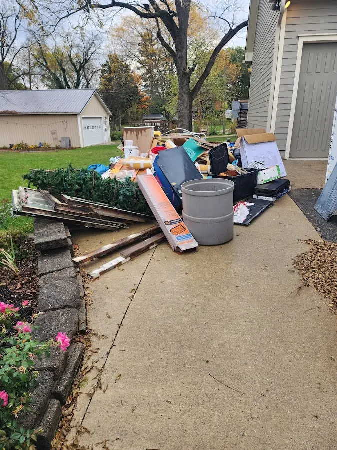 Dumpster being loaded with debris for 3 Yard Dumpster Rental in Blue Springs